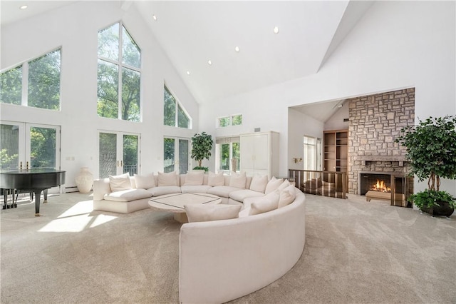 carpeted living room featuring a fireplace, high vaulted ceiling, and french doors