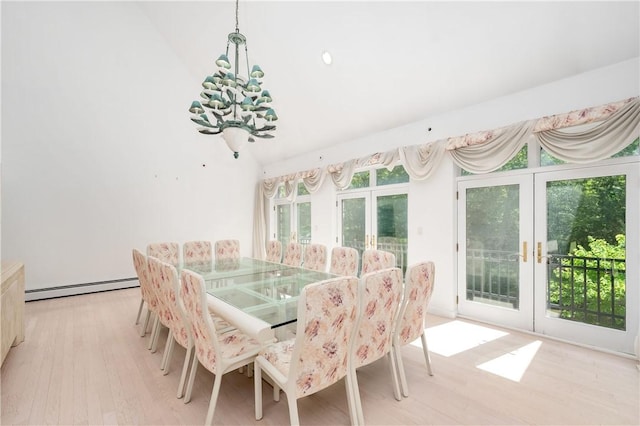 dining area featuring french doors, light hardwood / wood-style floors, and a baseboard heating unit