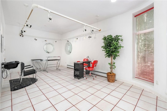 tiled dining space with a baseboard heating unit