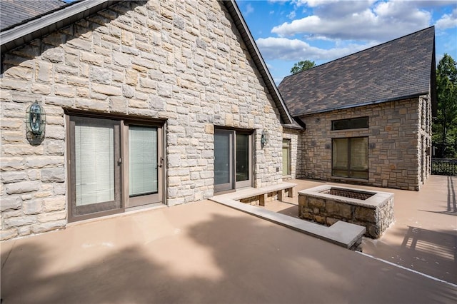 back of house featuring a fire pit and a patio area