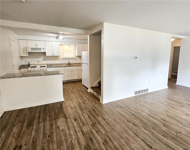 kitchen featuring white cabinets, dark hardwood / wood-style flooring, white appliances, and stone countertops