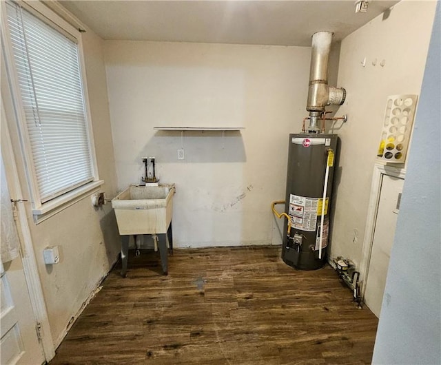 utility room featuring sink and water heater