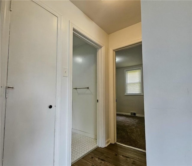 hallway with dark hardwood / wood-style flooring