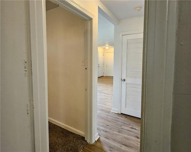 hallway with light hardwood / wood-style floors