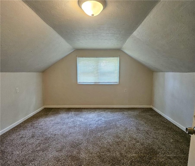 bonus room featuring carpet, a textured ceiling, and vaulted ceiling