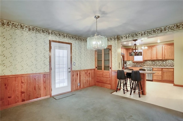 dining room featuring light colored carpet and a chandelier