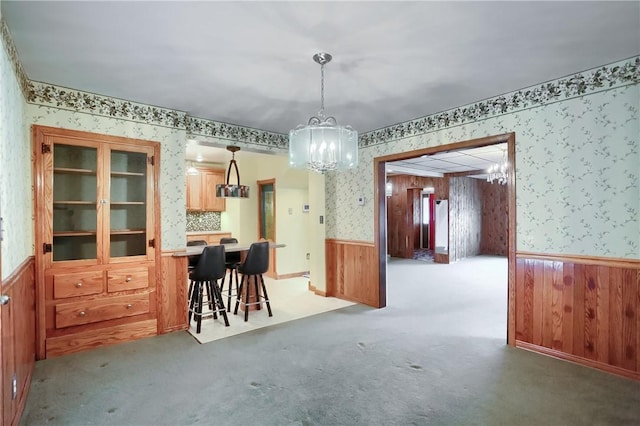 dining area featuring a chandelier and carpet flooring