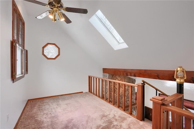 additional living space featuring lofted ceiling with skylight and carpet floors