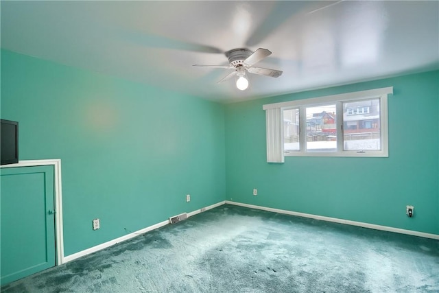 carpeted spare room with ceiling fan