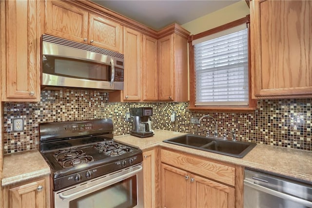 kitchen featuring appliances with stainless steel finishes, sink, and backsplash