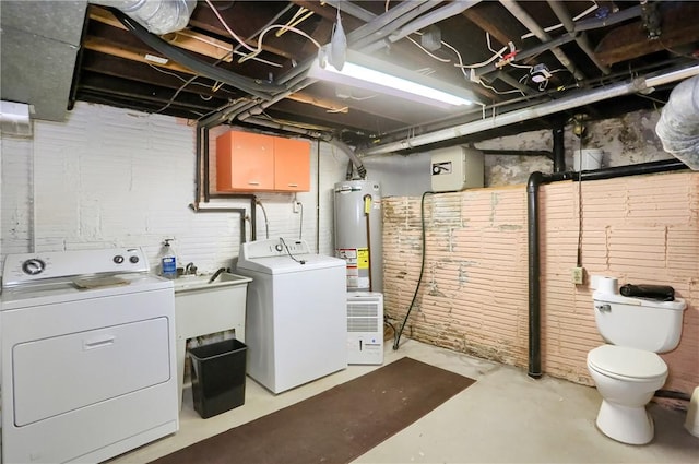 clothes washing area with sink, washing machine and dryer, and water heater