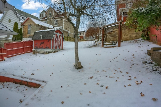 snowy yard with a shed