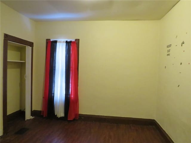 spare room featuring dark hardwood / wood-style flooring