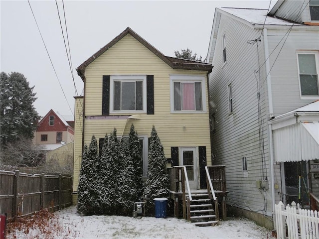 view of snow covered rear of property