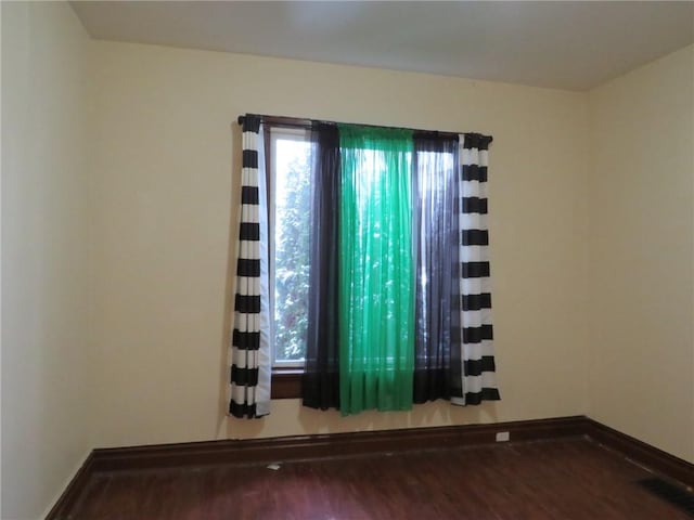 spare room featuring hardwood / wood-style flooring