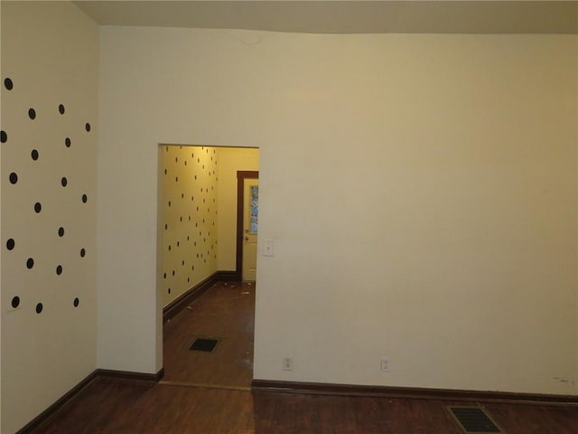 unfurnished room with dark hardwood / wood-style flooring