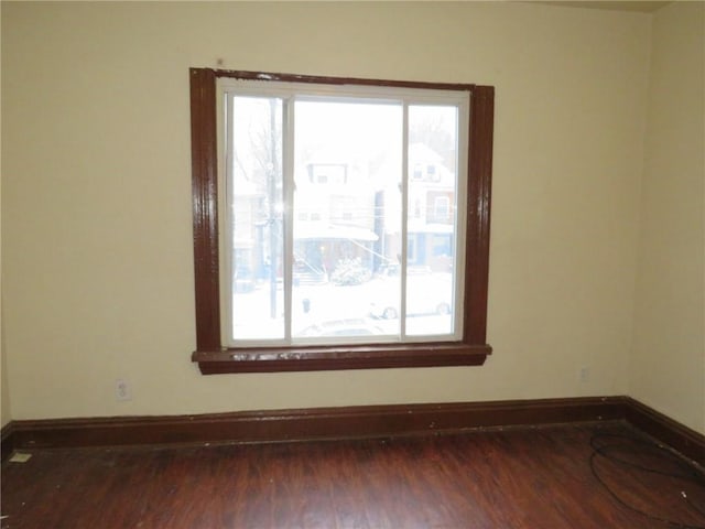 unfurnished room with dark hardwood / wood-style floors