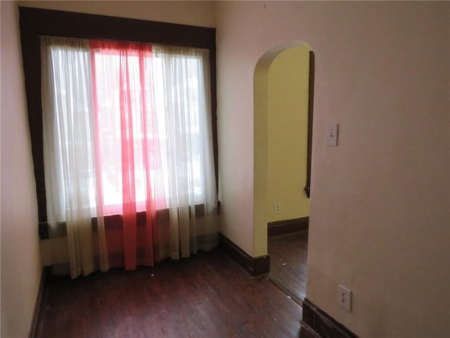 unfurnished room featuring dark hardwood / wood-style flooring