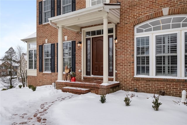 view of snow covered property entrance