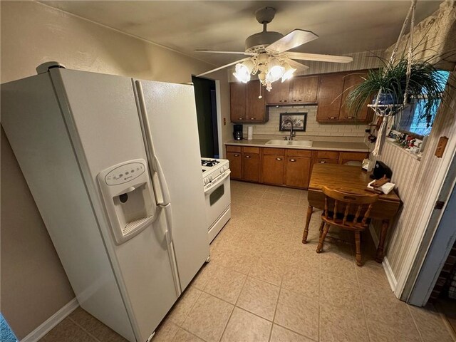 kitchen featuring ceiling fan, sink, backsplash, lofted ceiling, and white appliances