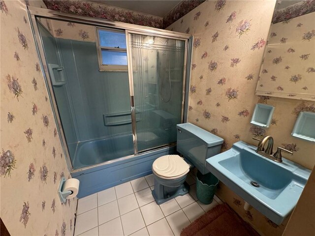 full bathroom featuring tile patterned floors, shower / bath combination with glass door, sink, and toilet