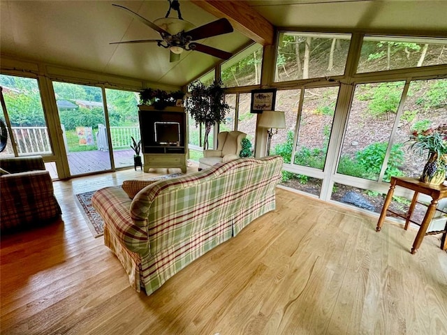 sunroom with vaulted ceiling with beams and ceiling fan