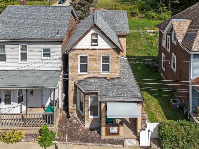 back of property featuring central AC