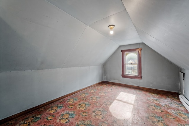 bonus room featuring lofted ceiling and a baseboard heating unit