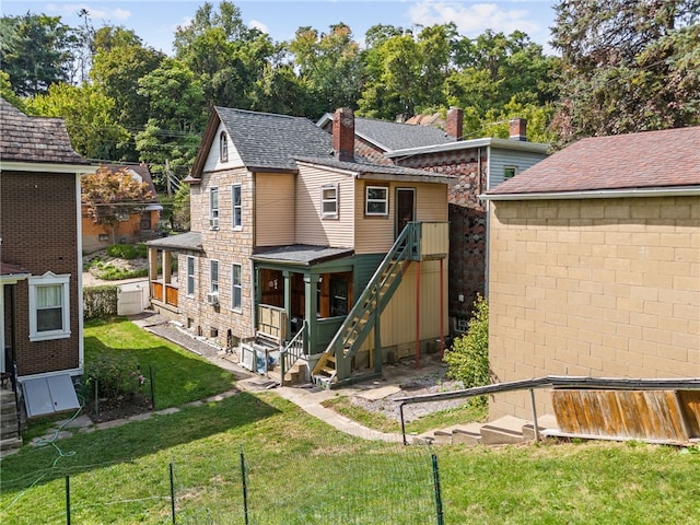 back of house featuring a lawn