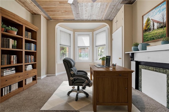 carpeted office space with wood ceiling