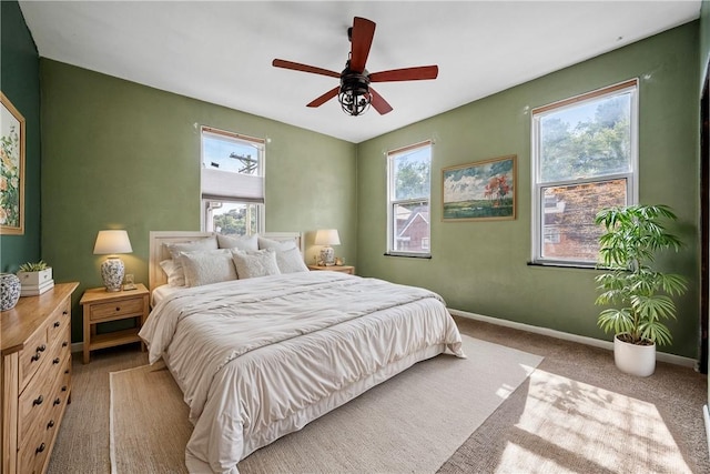 bedroom with ceiling fan and light carpet