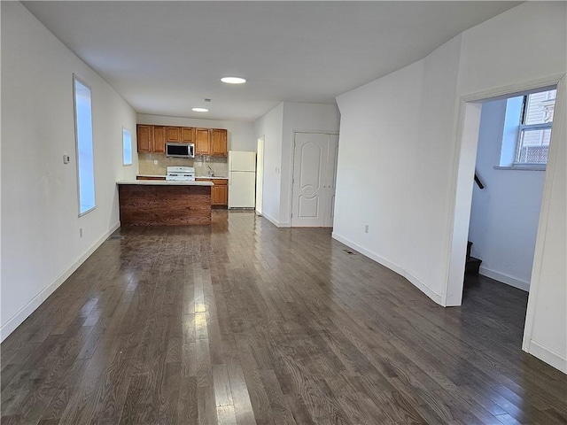 unfurnished living room featuring dark hardwood / wood-style flooring