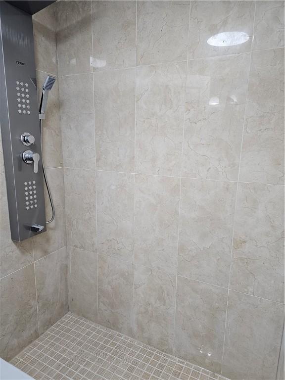 bathroom with tiled shower