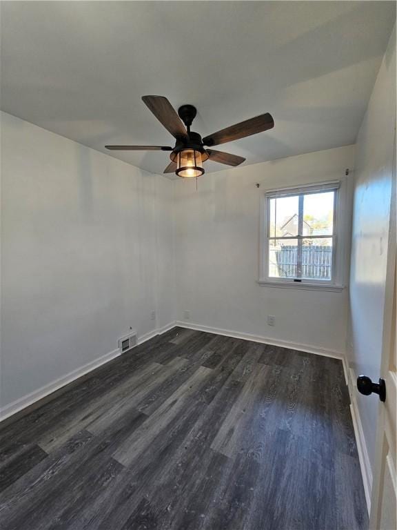 spare room featuring ceiling fan and dark wood-type flooring