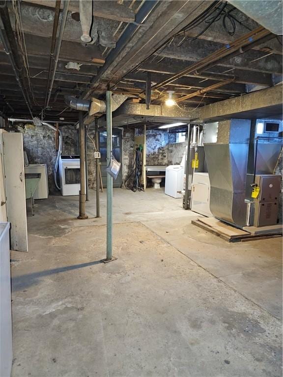 basement featuring washer / clothes dryer and heating unit