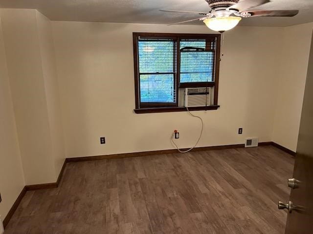 spare room featuring hardwood / wood-style flooring, ceiling fan, and cooling unit