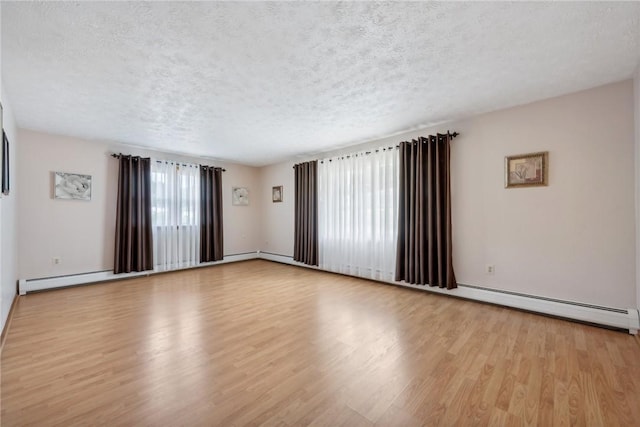 unfurnished room with a textured ceiling and light wood-type flooring