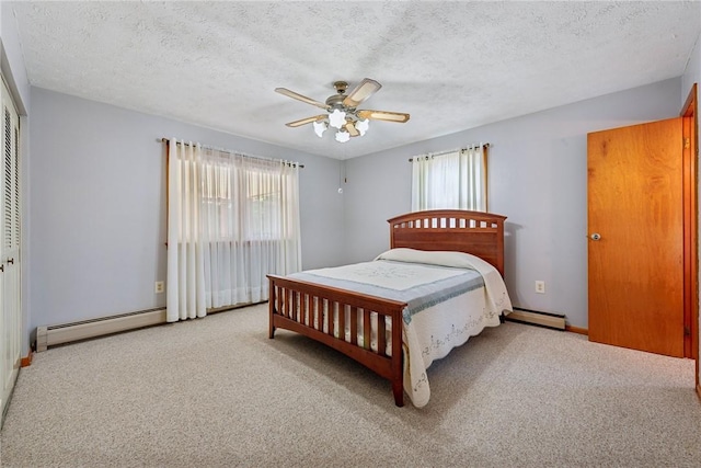 carpeted bedroom featuring a textured ceiling, ceiling fan, baseboard heating, and a closet