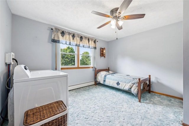 carpeted bedroom with ceiling fan, washer and clothes dryer, and a baseboard heating unit