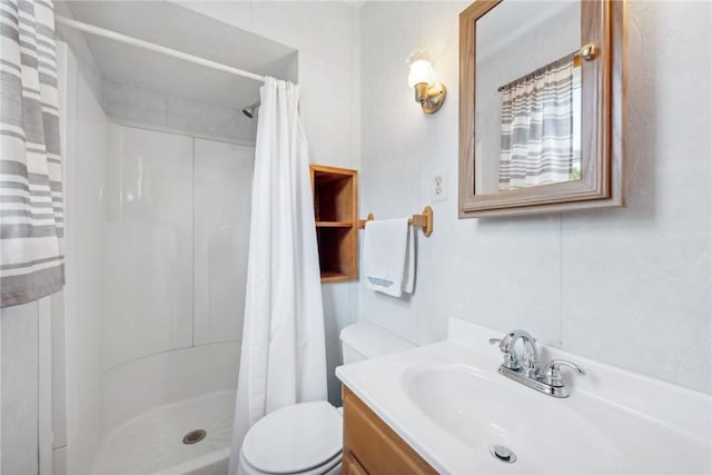 bathroom with vanity, toilet, and walk in shower