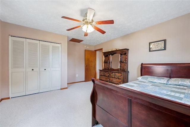 carpeted bedroom with a textured ceiling, a closet, and ceiling fan