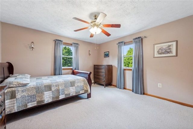 carpeted bedroom with a textured ceiling and ceiling fan