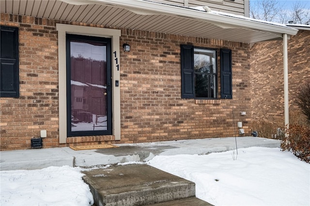 view of snow covered property entrance