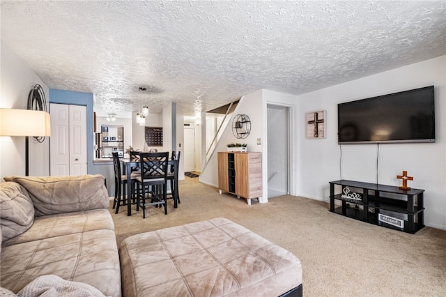 carpeted living room featuring a textured ceiling