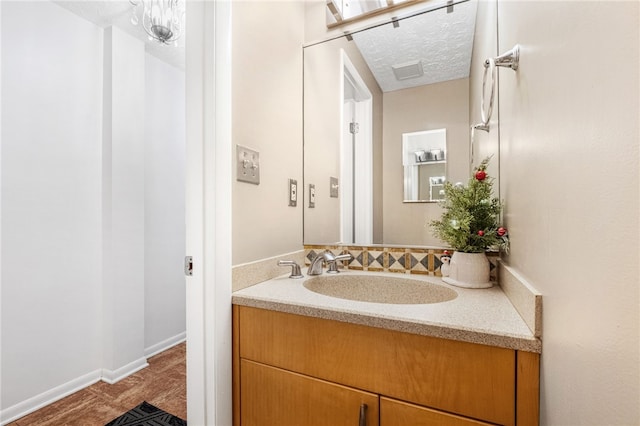 bathroom with vanity and a textured ceiling