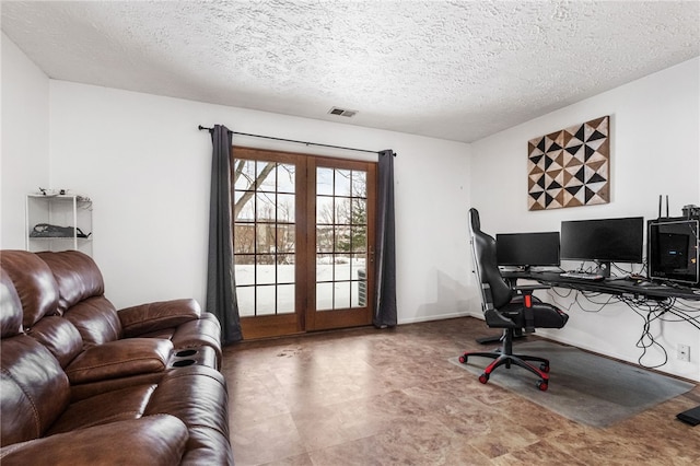 office area featuring french doors and a textured ceiling