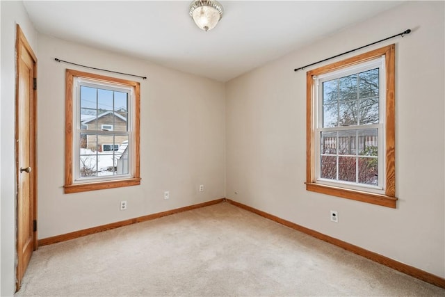 carpeted empty room featuring a wealth of natural light