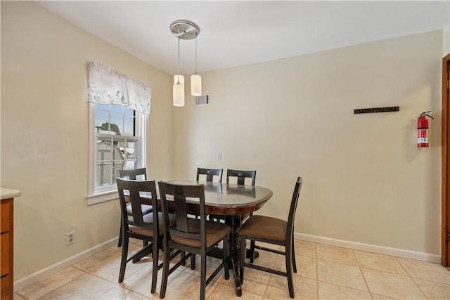 dining space featuring light tile patterned flooring