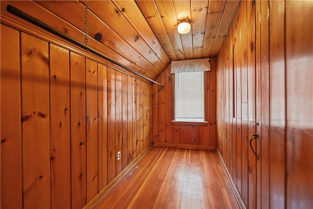 bonus room featuring wooden walls, hardwood / wood-style floors, wooden ceiling, and lofted ceiling