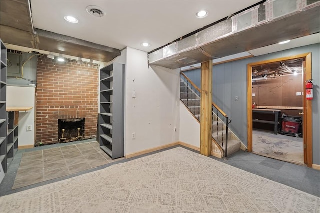 basement with a brick fireplace